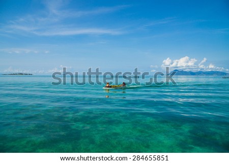 Alone sea gypsy boat at open sea with blue sky