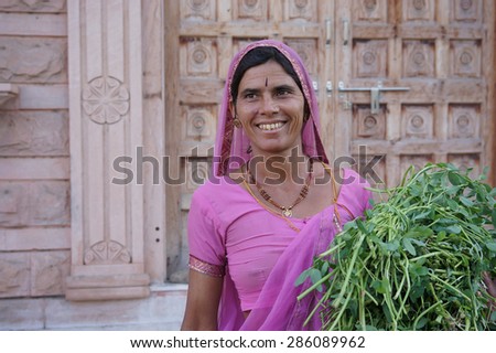 PUSHKAR, INDIA - FEBRUARY 17: An unidentified lady smile to tourist at Pushkar Town on February 17, 2015 in Pushkar, Rajasthan, India. with her the typical colored dress