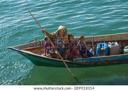 SEMPORNA, MALAYSIA - JUNE 5 : Family of Sea Gypsy (Bajau Laut) at their boat house June 5th, 2014 in Semporna, Sabah, Malaysia. The Bajau Laut are the sea gypsies who live in the open sea
