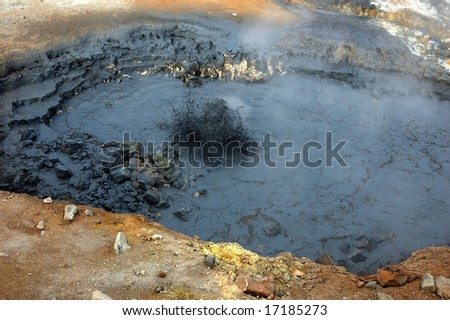 Geyser with a boiling dirt in a zone of volcanic activity in Iceland