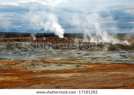 Geyser throwing out steam against a volcano cone in Iceland