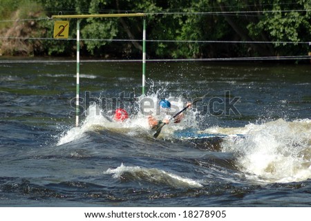 The double sports kayak passes gate at competitions on a rowing slalom