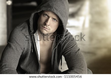 Cool young guy in hooded jacket