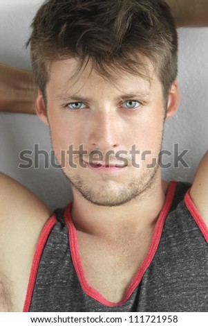 Close-up detailed portrait of a nice looking young man with sexy smirk