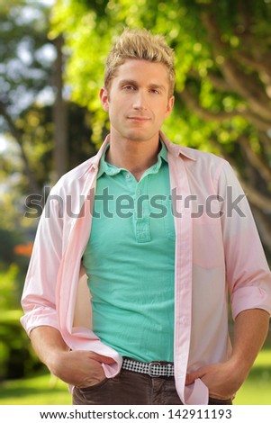 Outdoor portrait of a casual relaxed young man in bright clothing