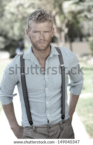 Outdoor portrait of a confident sexy young man