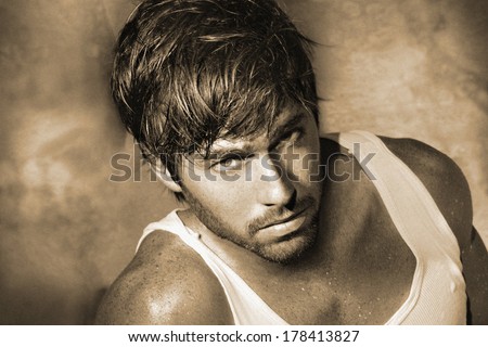 Vintage stylized monochrome sepia classic portrait of young male model (Photo has an intentional film grain)