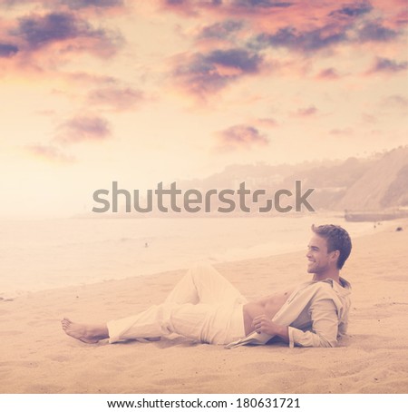 Young happy man with great smile on the beach with dramatic sky and overall vintage toning and styling