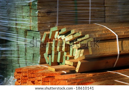 colored lumber piled up in a factory