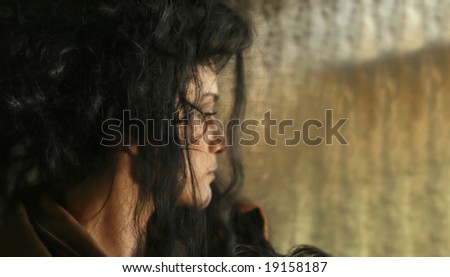 woman looking out a window with her hair pulled up