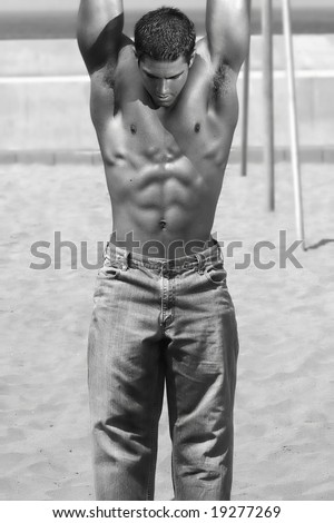 Black and white photo of young fit man hanging