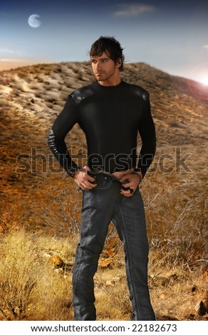 Full body fashion portrait of young good looking male model against an otherworldy background