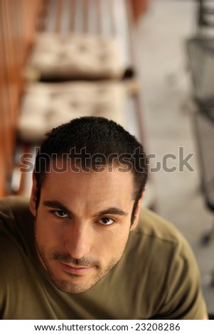 Portrait of a good looking man at an outdoor cafe with copy space above