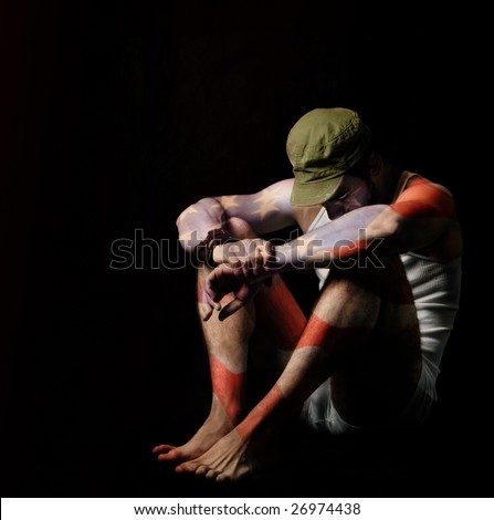 Fine art full body portrait of a soldier in American flag body paint and green army hat against black background
