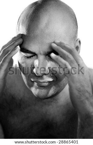 Fine art black and white portrait of a bald man with hands on face against white background in hard light