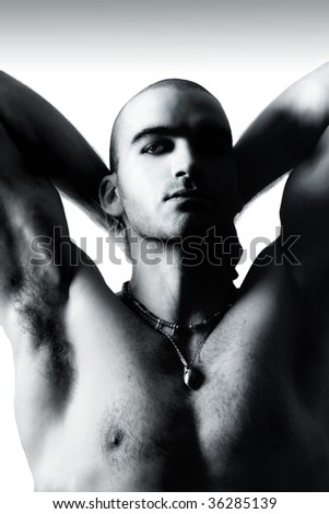  Black and white portrait of a sexy young shirtless man with shaved head