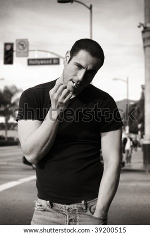 Classic black and white portrait of rugged good looking man smoking