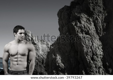 Stylized portrait of young male shirtless bodybuilder with mountain, ocean, and sky behind him