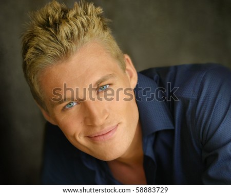 Close up portrait of a young happy blond man