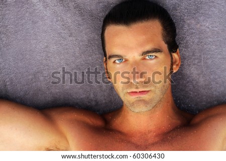 portrait of beautiful suntanned young man with blue eyes