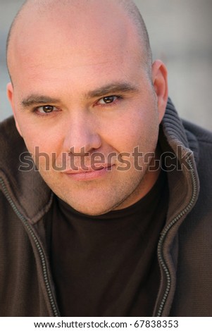 Closeup portrait of a confident middle aged man with shaved head
