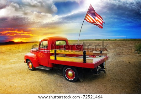 stock photo Red vintage pick up truck with American flag in wide open