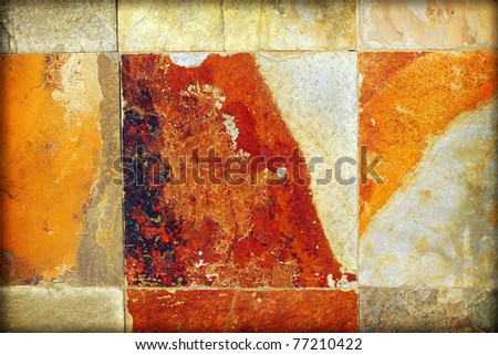 Detail abstract of old aged stone wall with brown, tan, orange, and white