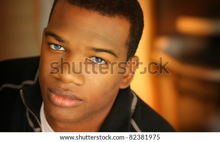 Portrait of a young man with dark skin and light eyes