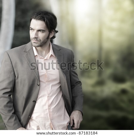 Portrait of elegant man in suit outdoors with lots of copy space