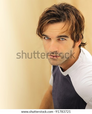 Portrait of a casual good looking male model with striking blue eyes