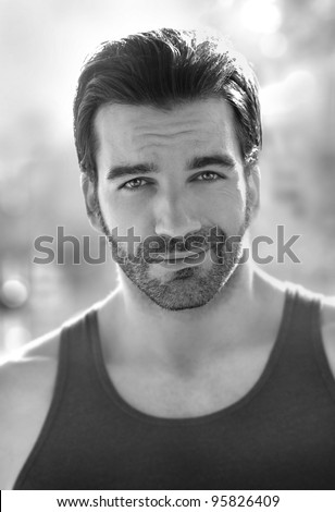 Outdoor black and white portrait of a classically good looking masculine man outdoors