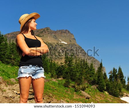 Beautiful girl looking out at the horizon over Logan Pass in Glacier National Park Montana.