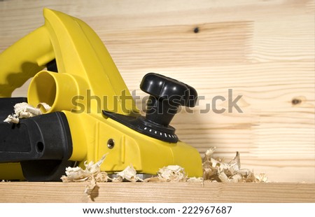 yellow electric plane on a board of wood