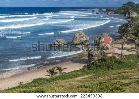 Bathsheba on the Atlantic east coast of the Caribbean island of Barbados in the West Indies. An abandoned pink house can be seen on the beach that has been wrecked by storms.