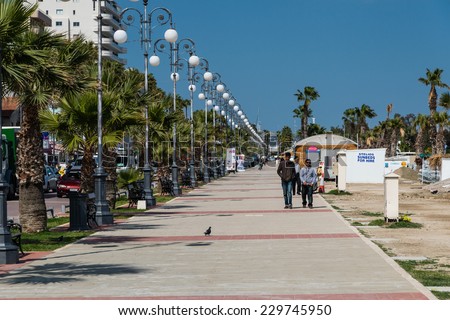 LARNACA, CYPRUS - MARCH  14,2014 : Seafront walkway at Foinikoudes Beach Larnaca on the south coast of the Mediterranean island of Cyprus.