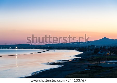 View towards the city of Larnaca in southern Cyprus during the evening twilight, with the Troodos Mountains on the horizon. Cyprus is an island in the Mediterranean Sea.