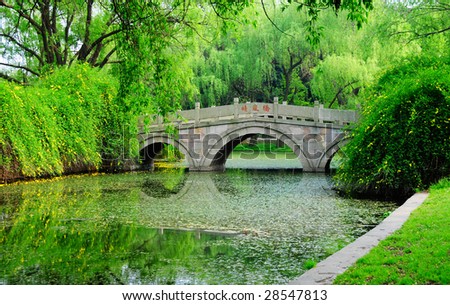 a chinese traditional stone bridge at park