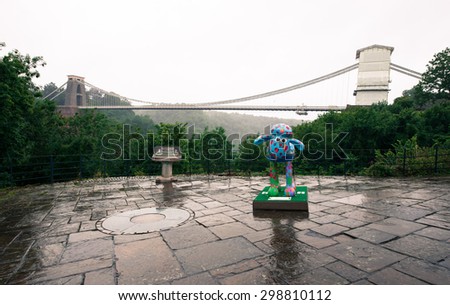 Clifton suspension bridge in Bristol city, and shaun the sheep charity sculpture, in a rainy day. July 13, 2015, UK.