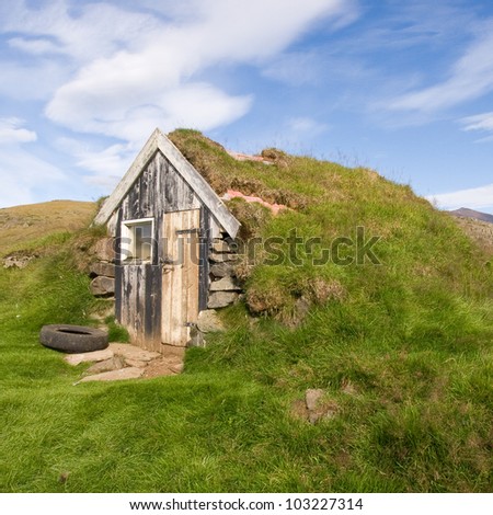 Little house with a turf roof in countryside in Iceland.