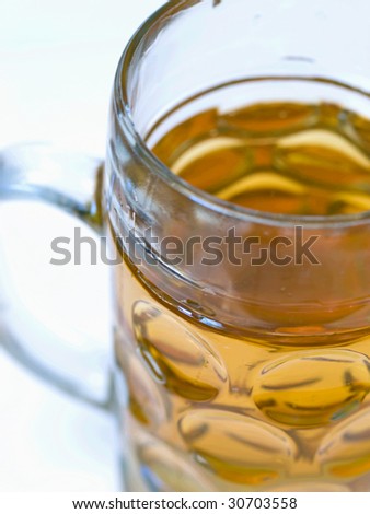 Close-up of a light beer in a big beer glass without foam