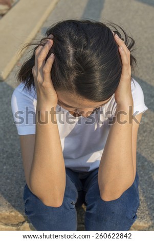 Woman with a headache, took her hand on her head.
