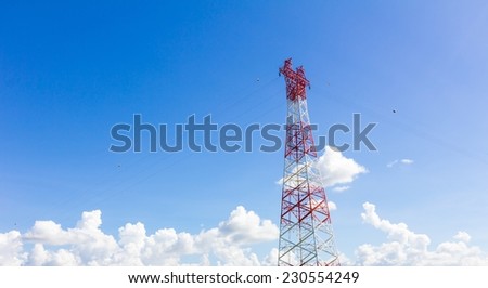 Telecommunication mast with microwave link and TV transmitter antennas on blue sky