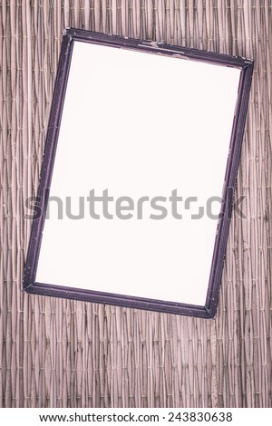 wooden old black picture frame on traditional mat with white space in the middle, vintage filter