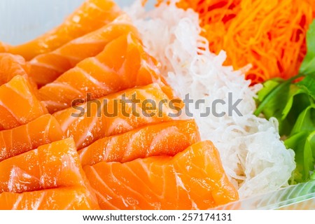 extreme close-up orange salmon fish cut with slices with vegetables