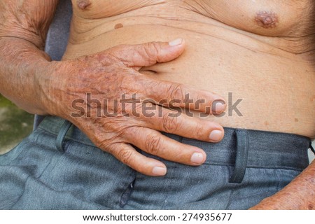 close-up old man with big belly has stomachache