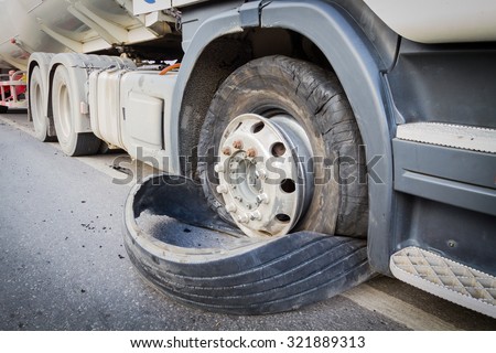 closeup damaged 18 wheeler semi truck burst tires by highway street