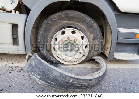 closeup damaged 18 wheeler semi truck burst tires by highway street.