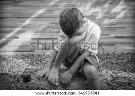 scared and alone, young homeless Asian child who is at high risk of being bullied, trafficked and abused