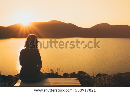 The silhouette of woman sitting alone, concept of lonely, sad, alone, person space, alone and scared