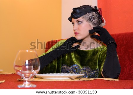 beauty girl at the table with empty plate and glasses